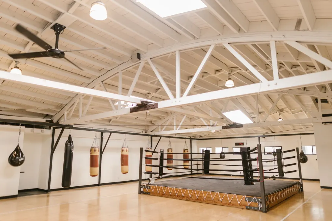 Training floor under a wood roof with the equipment racked and nobody in the room