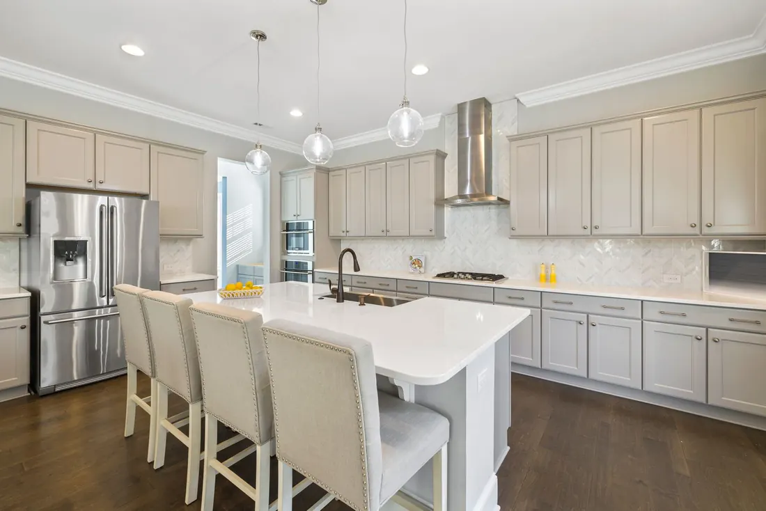 Kitchen island with stools pushed in and nothing left standing on the counter